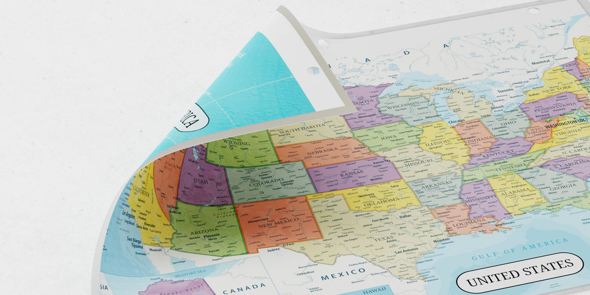 A laminated United States map binder insert, punched for a three-ring binder, curling up to show the reverse side