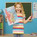 Young girl holding a world map and colorful pencils in a classroom setting